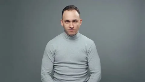 Shooting of young grumpy man in turtleneck Stock Footage 127949344