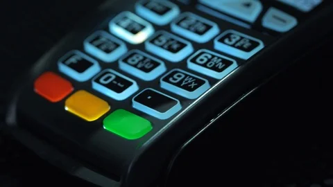 Shop assistant inserting a credit card into a pos and inserting pin-code of the Stock Footage 89326435