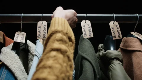 Shop assistant preparing black friday tags for Clothes Video stock 254855676