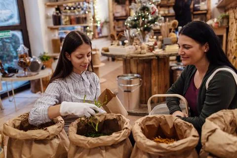 Shop assistant serving customer in packaging free shop. Stock Photos