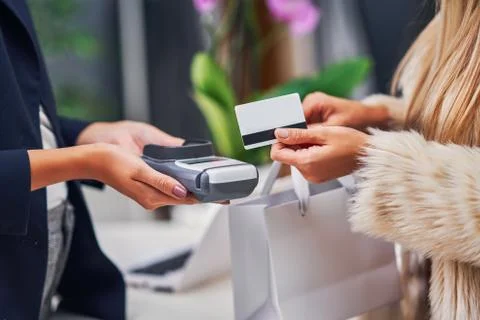 Shop assistant serving the customer in store Stock Photos