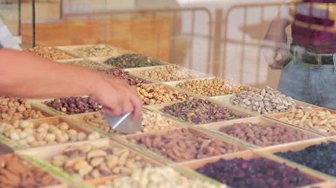 Shop with different nuts, customer selects the type of nuts Stock Footage 68952450
