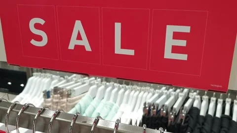 Shop. Hangers with clothes of different sizes. Sales time. Stock Footage 133352161