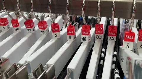 Shop. Hangers with clothes of different sizes. Stock-Footage 133352176