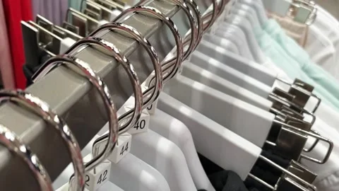 Shop. Hangers with clothes of different sizes. Stock Footage 133359386