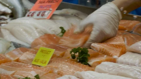 Shop keeper selects salmon fillets Stock Footage 90407061