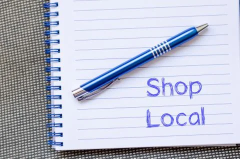 Shop local write on notebook Foto stock