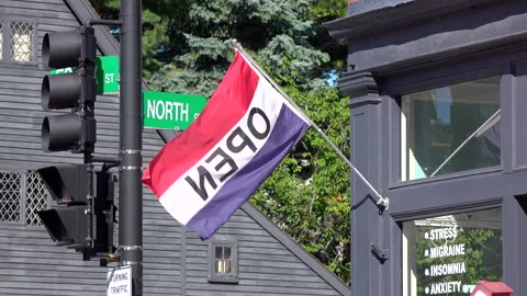 Shop OPEN flag hanging in small town 4k Stock Footage 146410743