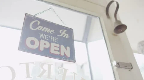 Shop sign hanging in the window of a small, traditional store Stock Footage 23329172