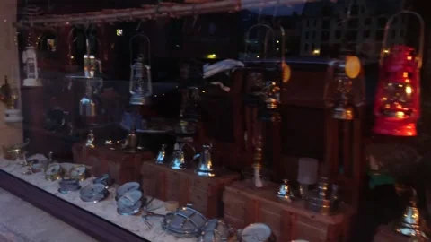 Shop window displays lanterns and bells on crates, in medium shot Video stock 325227780
