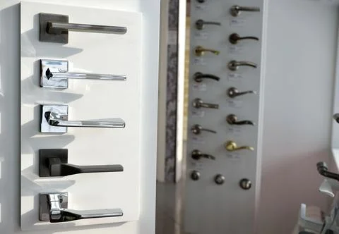 Shop window with a large selection of handles for interior doors. accessories Stock Photos