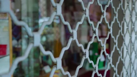 Shop window protected by iron security shutter grate 動画素材 162176346