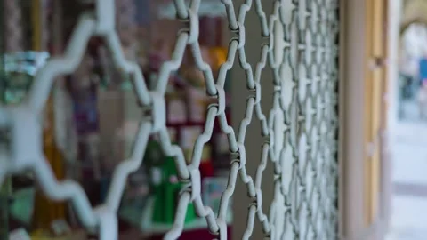 Shop window protected by metal bars security shutter grate 動画素材 162575013