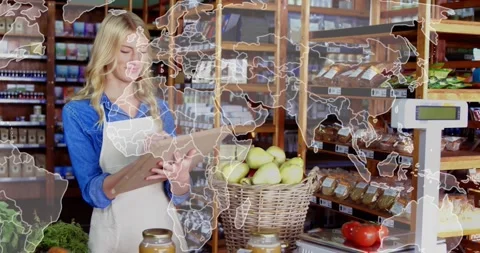 Shop worker scanning clipboard checking apples and scale for stock while map Stock Footage 333965109