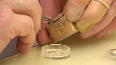 Shop worker under the microscope, manually collecting mechanism watches Stock Footage 45600489