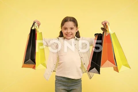 Shopaholic. little shopaholic with many shopping bags. little girl shopaholic on Stock Photos
