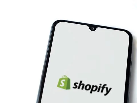 Shopify app launch screen on smartphone on white background Stock Photos