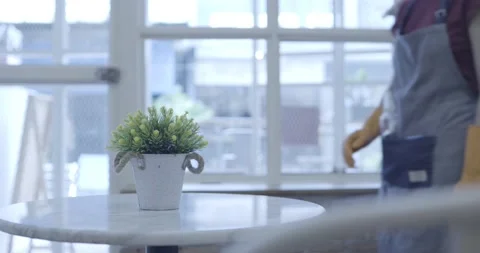 Shopkeeper cleaning table preparing to open shop Stock Footage 133641625
