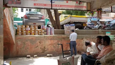 A shopkeeper is counting cardboard boxes for parcels and other customers Video stock 255610227