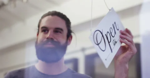 Shopkeeper opens shop by turning open sign. Shot on RED Epic. Stock Footage 59738102