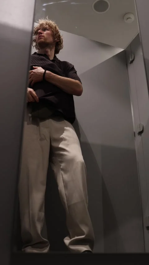 Shoplifter secretly steals clothes from a fitting room in a clothing store Stock Footage 344855105
