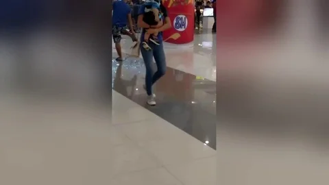 Shopper calmly puts out electrical fire by throwing his FLIP-FLOPS at flames 스톡 동영상 105831456