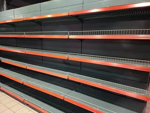 A shopper encounters empty racks in the grocery store 스톡 사진