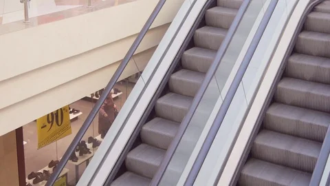 Shopper On Escalator In Shopping Mall Using Mobile Phone 스톡 동영상 73364372