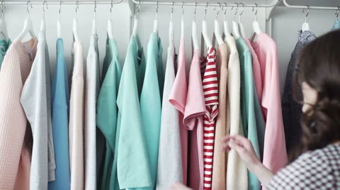Shopper looking at clothes in clothes store. Stock Footage 63410204