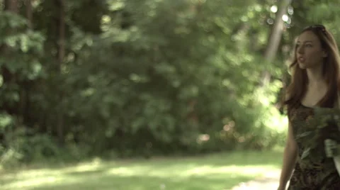 Shopper stops with cellphone in park 4K Stock Footage 41295741