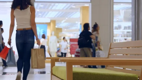 Shopper Walking Away from Camera Carrying Shopping Bags Stock Footage 100597219