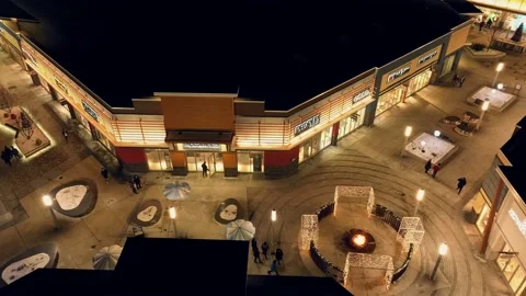 Shoppers and consumers walk through outdoor outlet mall to do their Stock Footage 227091916