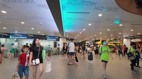 Shoppers and visitors walk through the spacious concourse of VivoCity Stock Footage 341269559