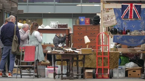 Shoppers browsing amongst the Stall holders in Old Spitalfields Market Stock Footage 90236146