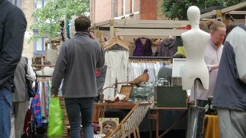 Shoppers browsing amongst the Stall holders in Old Spitalfields Market Stock Footage 90236176
