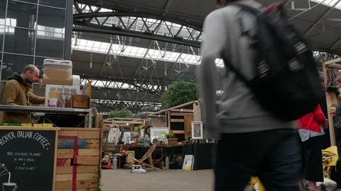 Shoppers browsing amongst the Stall holders in Old Spitalfields Market Stock Footage 90236415