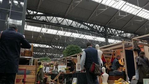 Shoppers browsing amongst the Stall holders in Old Spitalfields Market Stock Footage 90236487