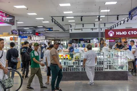 Shoppers in a bustling electronics market Stock Photos