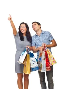 Shoppers couple pointing and looking up Stock Photos