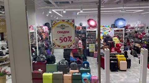 Shopper's delight: crowds navigate through a vibrant shopping center, immersed i Stock Footage 264803701