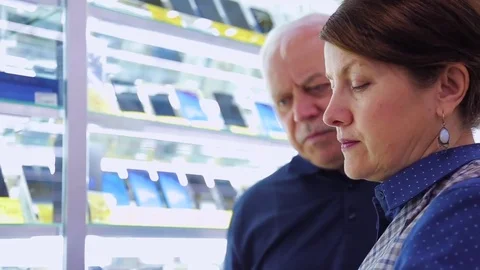Shoppers at an electronics store looking smartphones, closeup Stock Footage 77863363