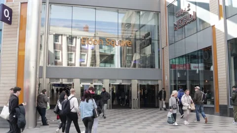 Shoppers entering and exiting Eldon Square shopping mall center with sign Stock Footage 172543454