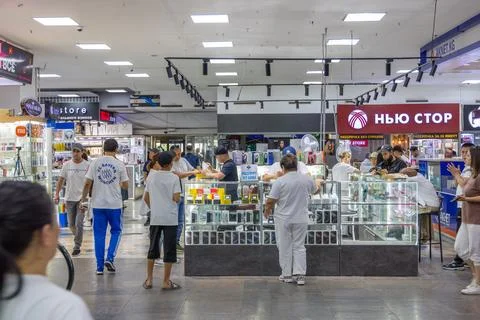 Shoppers explore electronics stores in Bishkek shopping mall Tsum Aichurok Stock Photos