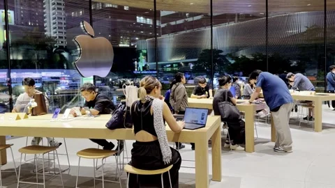 Shoppers explore the latest Apple iPhone and other devices Video stock 323315194