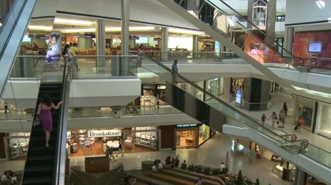 Shoppers moving through mall on escalators Stock Footage 32327041