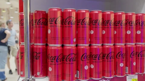 Shoppers passing by display of coca-cola cans in supermarket Stock Footage 283760159
