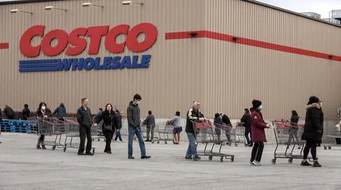 Shoppers Practicing Physical Distancing While Lining Up Outside Costco Store Stock Photos