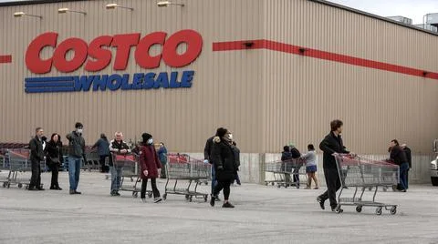 Shoppers Practicing Physical Distancing While Lining Up Outside Costco Store Stock Photos