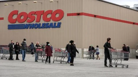 Shoppers Practicing Physical Distancing While Lining Up Outside Costco Store Stock Photos