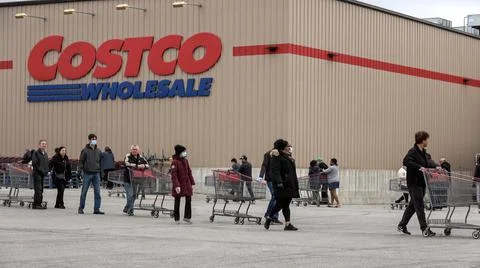 Shoppers Practicing Physical Distancing While Lining Up Outside Costco Store Stock Photos